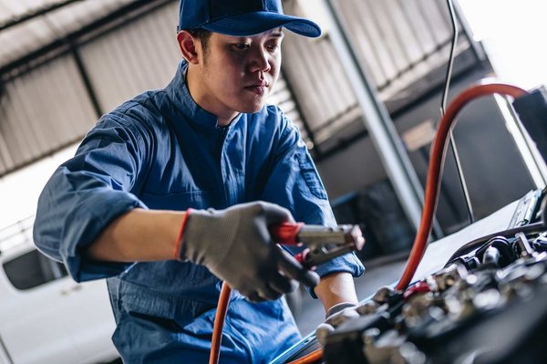 How should you maintain your vehicle's suspension system in the UK's frequent wet weather?